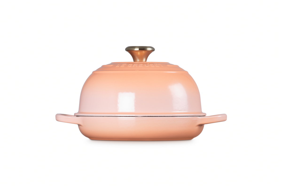 Front view of Signature Bread Oven in Peche showcasing domed lid and side handles against a white background