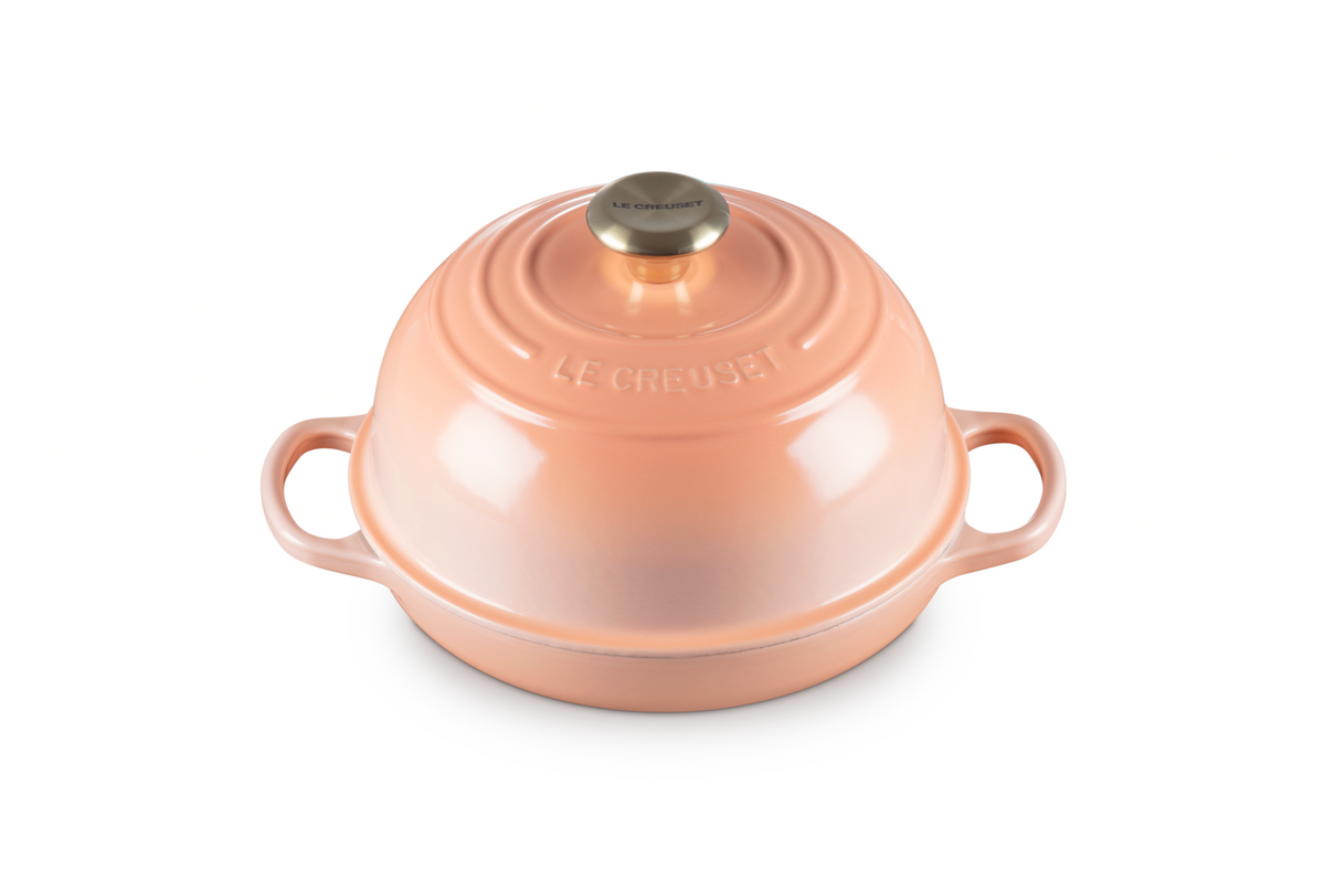 Front view of Signature Bread Oven in Peche showcasing its domed lid and side handles on a white background