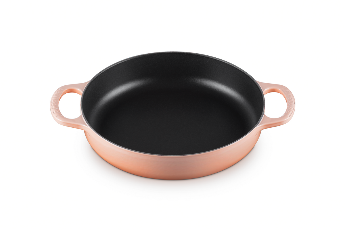 Three-quarter view of Signature Everyday Pan in Peche showcasing its black interior and two side handles on a white background