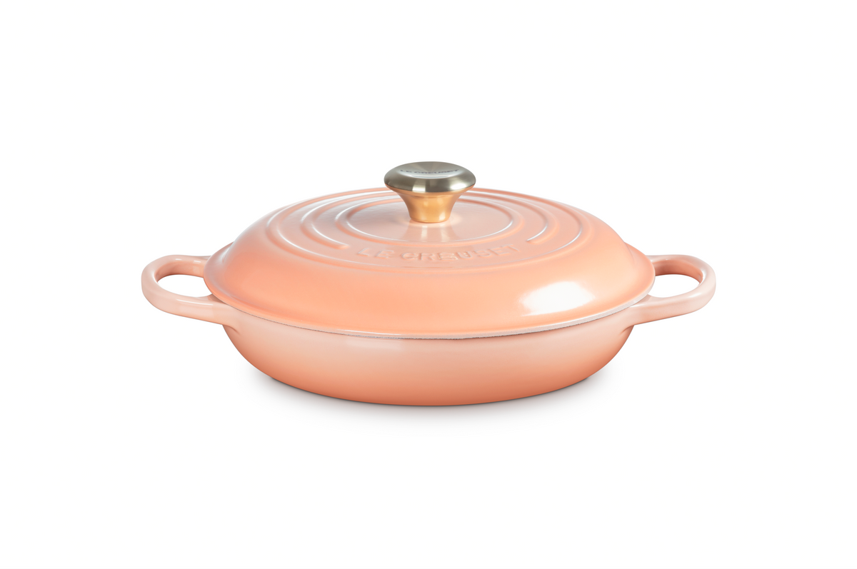 Front view of Signature Braiser in Peche showcasing its domed lid and wide loop handles with a white background