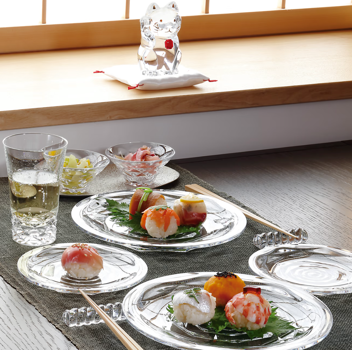 Lifestyle view of Everyday Swing Highball, Set of 2 showcasing a cut crystal base beside sushi plates