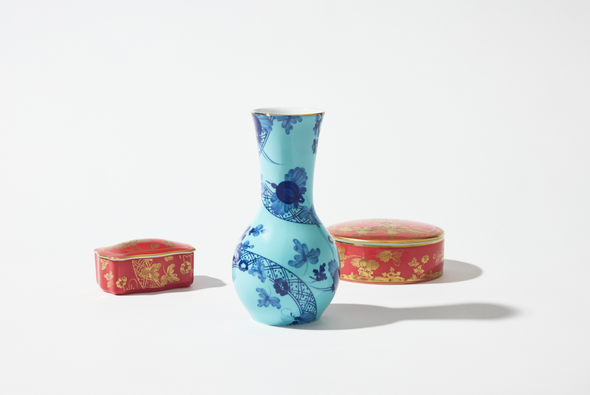 Front view of Flower Vase in Iris showing blue iris floral pattern and gold rim with two red decorative boxes on white background