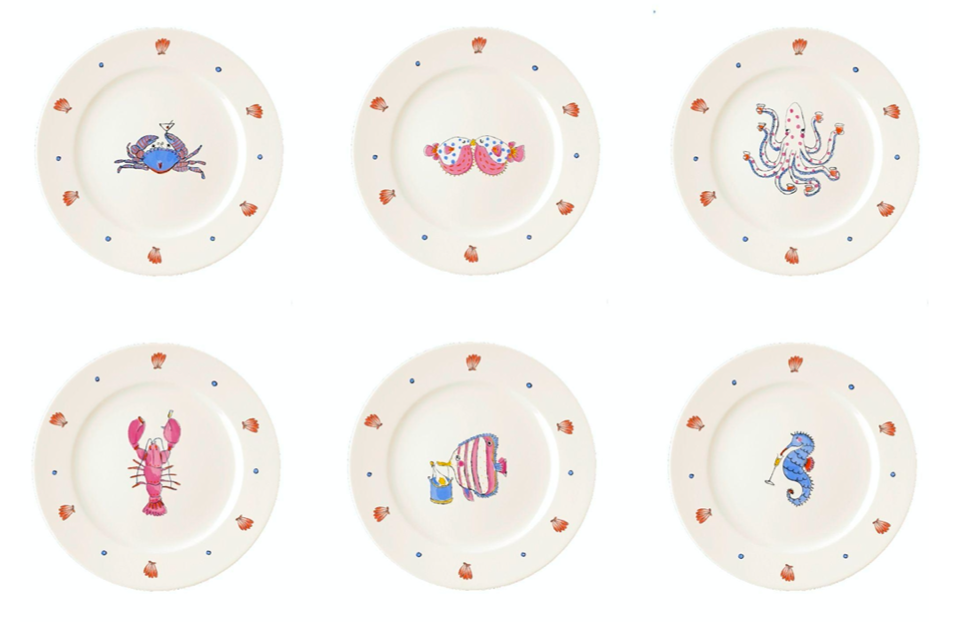 Top view of six porcelain dessert plates from the Sea Creature Series with hand-drawn sea creature motifs and scallop-dot rim on white background