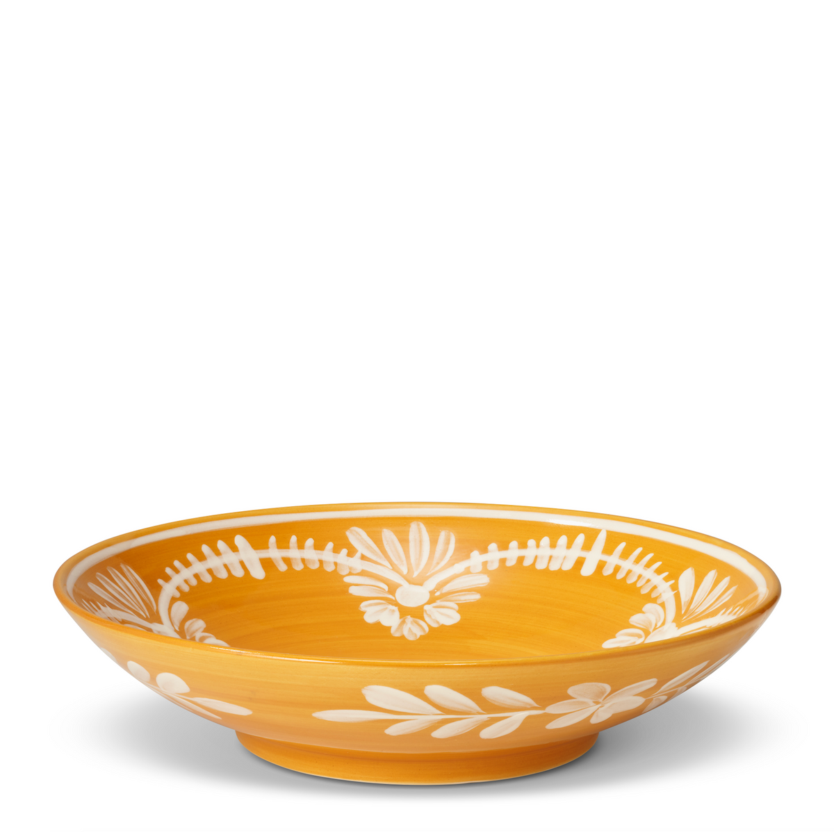 Three-quarter view of Serving Bowl With White Floral Trim in Marigold showcasing white floral trim with a white background