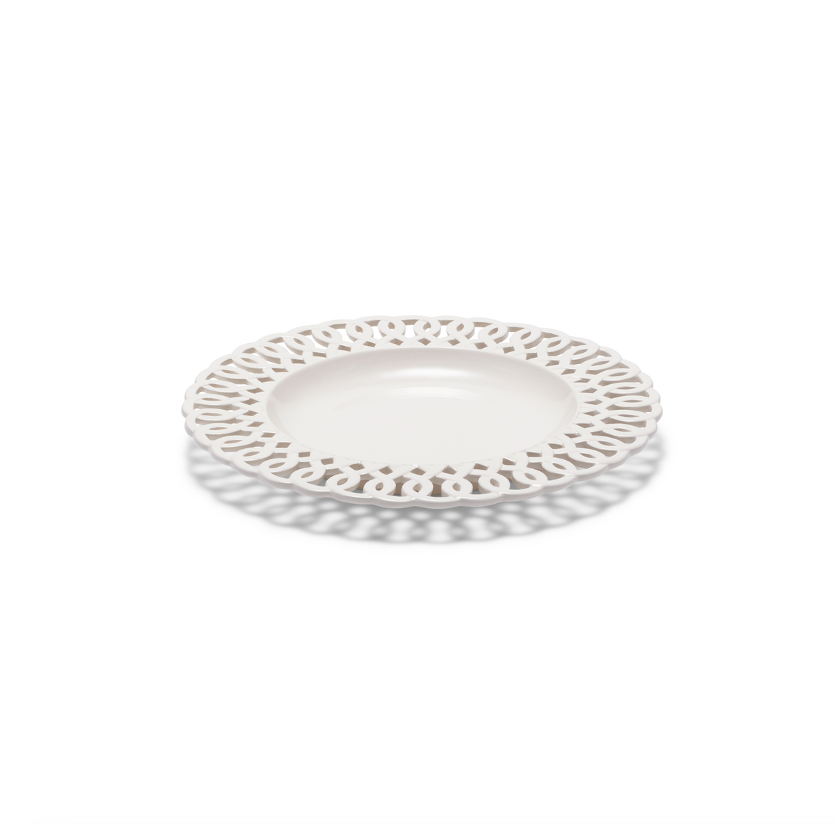 Angled view of Paulette Salad Plate in White showcasing its intricate cutout design with a white background