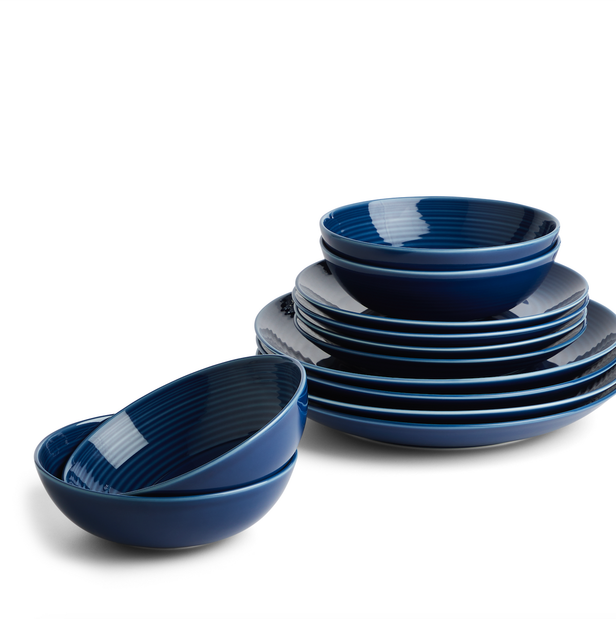Angled view of Gordon Ramsay Maze Denim 12 Piece Set showcasing blue stoneware plates and bowls with a white background