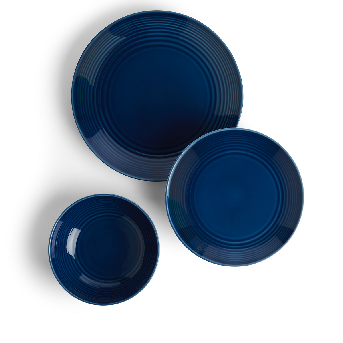 Top view of Gordon Ramsay Maze Denim 12 Piece Dinner Set showcasing blue glazed stoneware and circular design on white background
