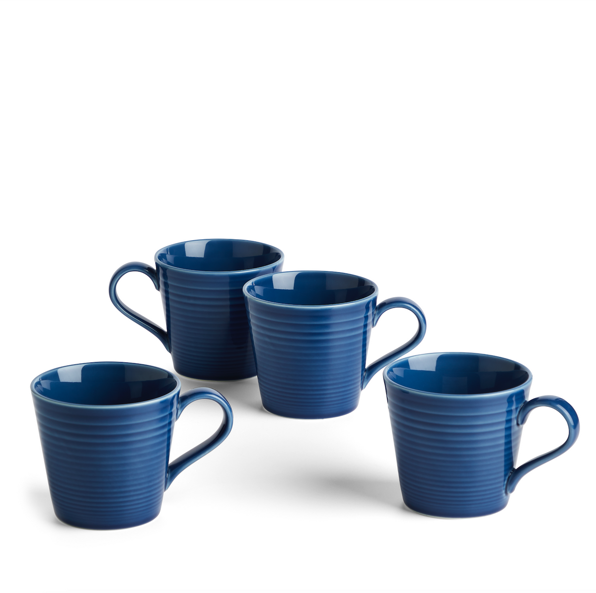 Front view of four Gordon Ramsay Maze mugs showcasing ribbed stoneware and blue glaze on a white background