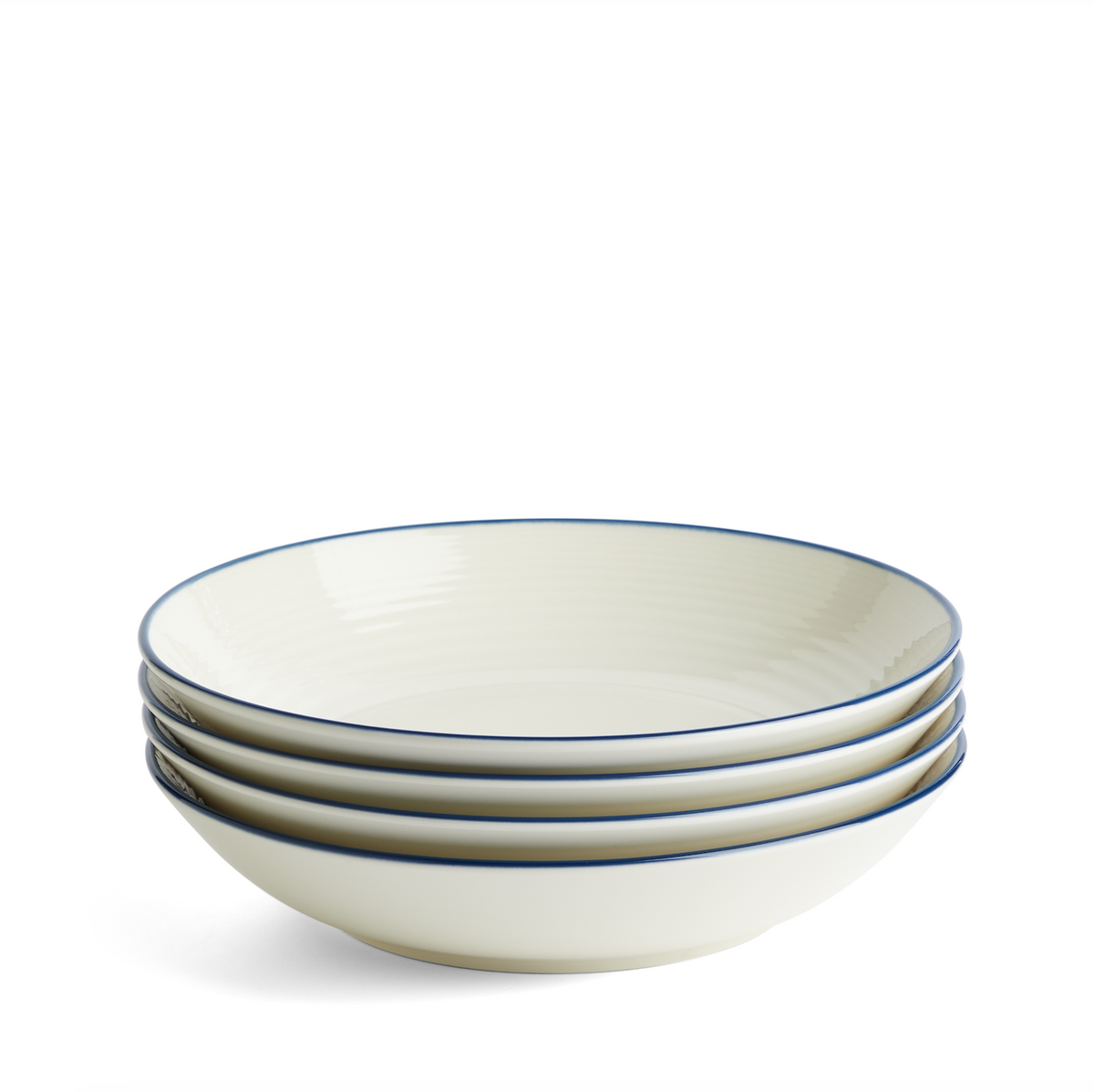 Angled view of Gordon Ramsay Maze Denim Line pasta bowls showcasing white stoneware and blue denim glaze rims on white background