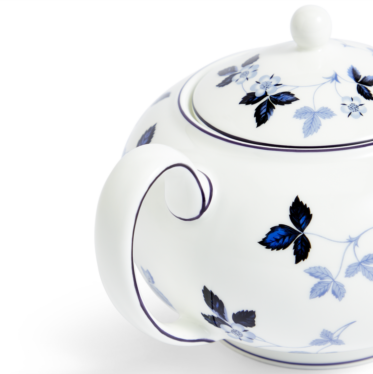 Close-up view of Wild Strawberry Inky Blue Teapot showcasing hand-sketched vines and strawberries with a white background