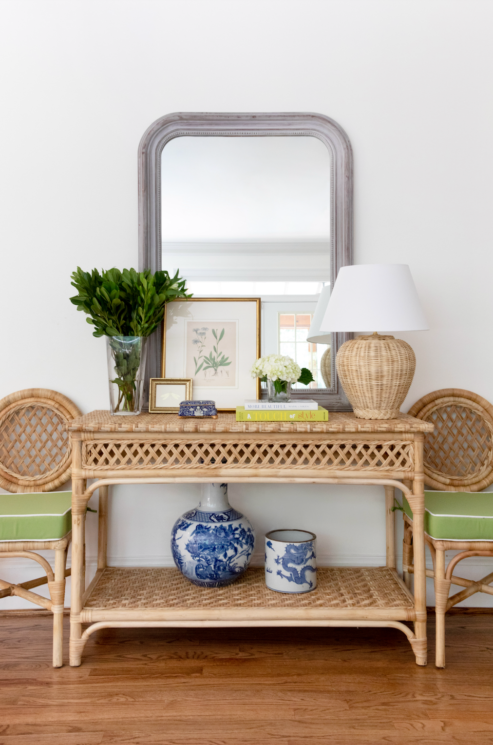 Front view of Trellis Console showing woven rattan trellis pattern and lower shelf in natural wicker against a white wall
