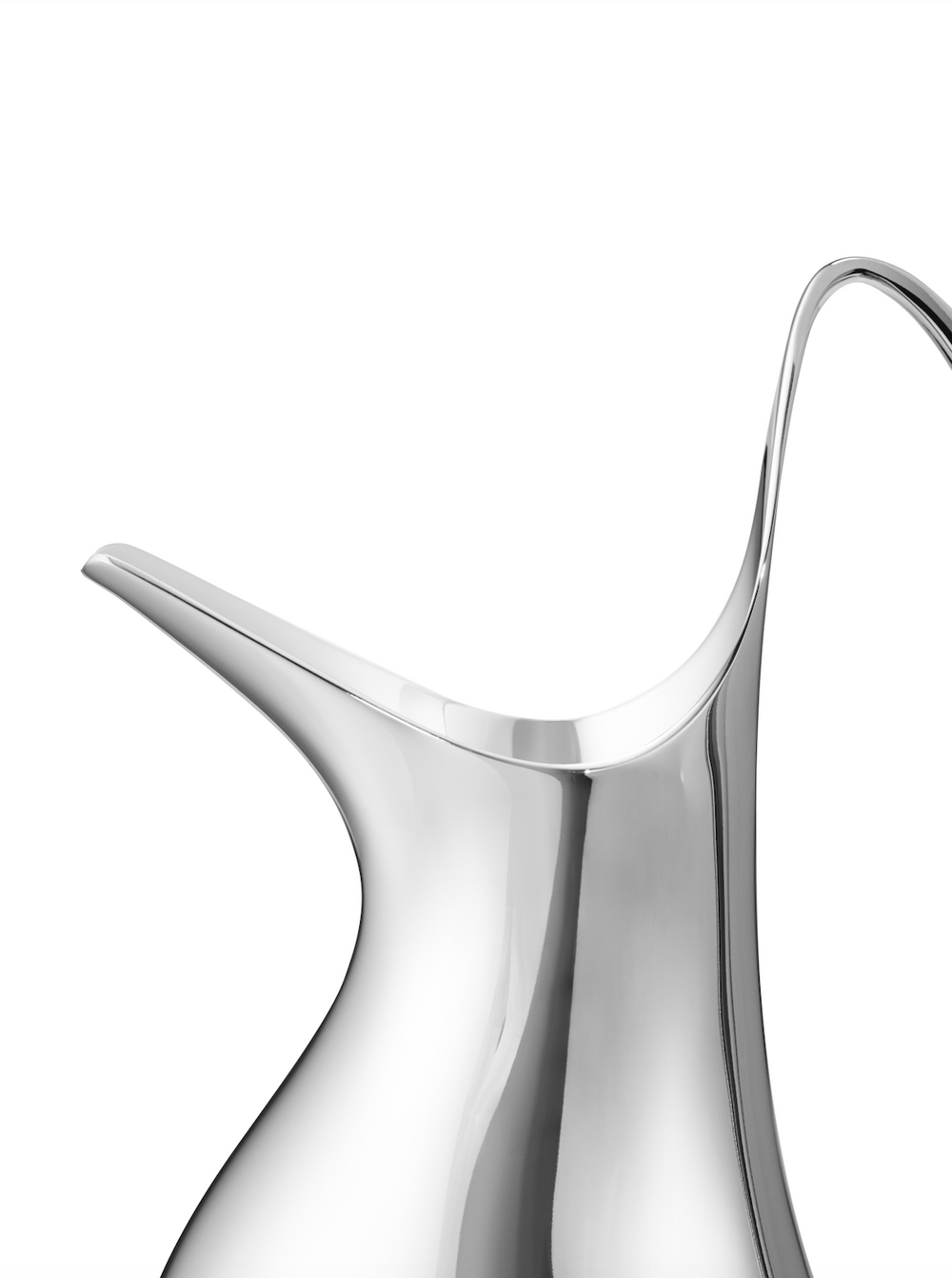 Close-up right-side view of Henning Koppel mini pitcher showcasing mirror-polished stainless steel curved body and spout on white background