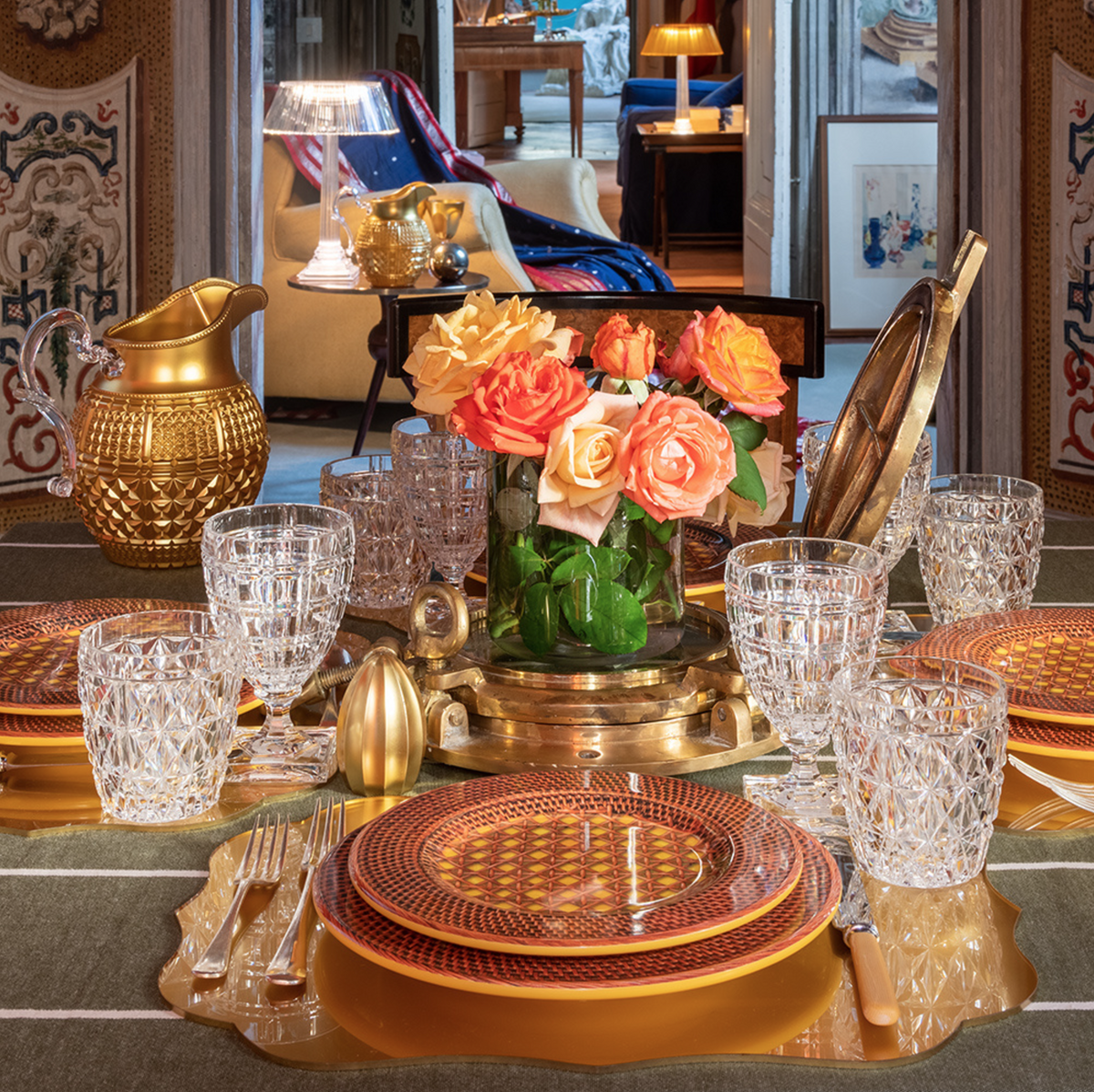 Winston acrylic water glass on a styled dining table with crystal tumblers, patterned plates, and orange roses