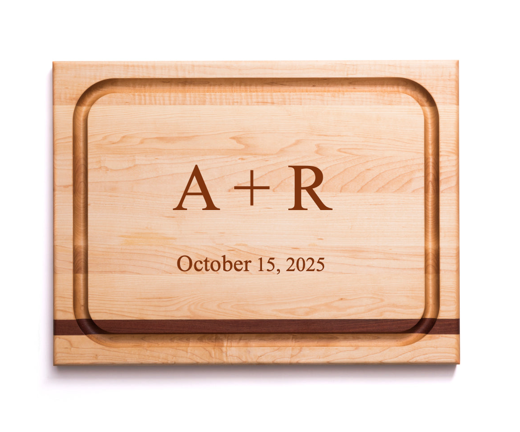Top view of maple carving board with mahogany inlay and juice groove, engraved ‘A + R’ and ‘October 15, 2025’