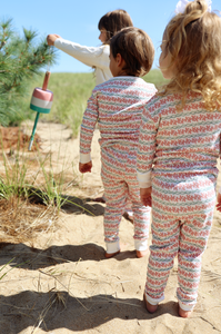 Back view of Christmas Lobsters Kids Henley Pajamas, set of 2, showing cream and red lobster print outdoors