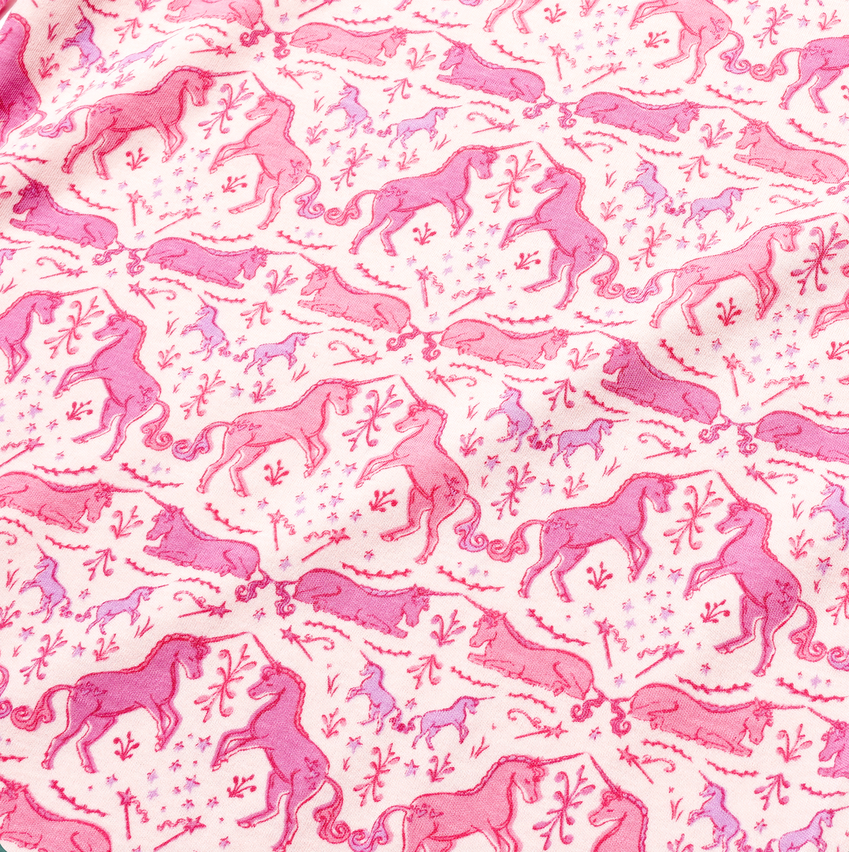 Close up of the Unicorns Lily Long Sleeve Play Dress showcasing its hand drawn unicorn print on pink and white fabric
