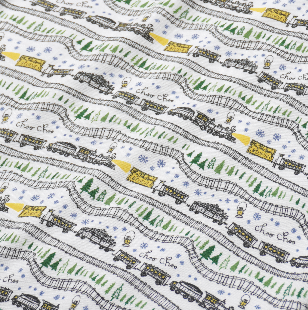 Close-up of Christmas Trains Zip Baby Onesie showcasing hand-drawn trains, Christmas trees, and snowy evergreens on a white background