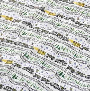 Close-up of Christmas Trains Kids Pajamas, set of 2 showcasing hand-drawn trains, Christmas trees, and snowy evergreens on white fabric