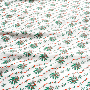 Close-up of Holly Baby Snap Onesie showcasing hand-drawn greenery and red berry print on white fabric