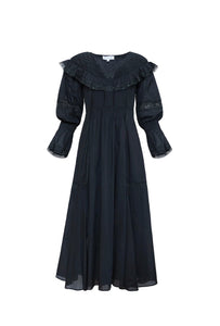 Front view of Selena Dress in Onyx showcasing embroidered round yoke, lace trim, smocking, and flowing skirt on white background