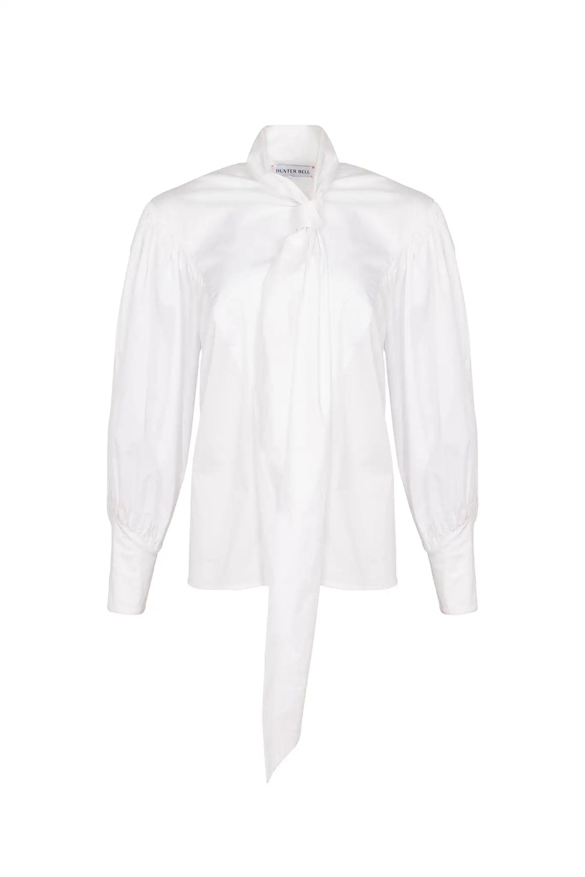 The Shay Blouse is designed with a tie-front neckline and long sleeves with angled button cuffs