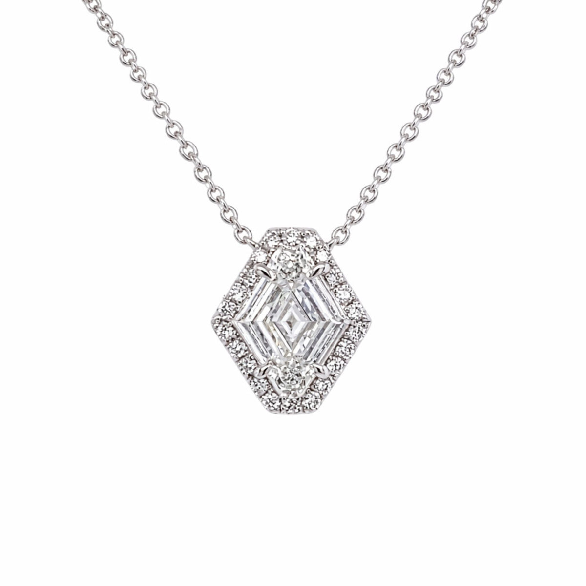 The North-South Shield Diamond Necklace with Pavé Halo in white gold features an 18-inch silver chain and a hexagon-shaped pendant adorned with clear gemstones and a pavé halo of sparkling round stones.