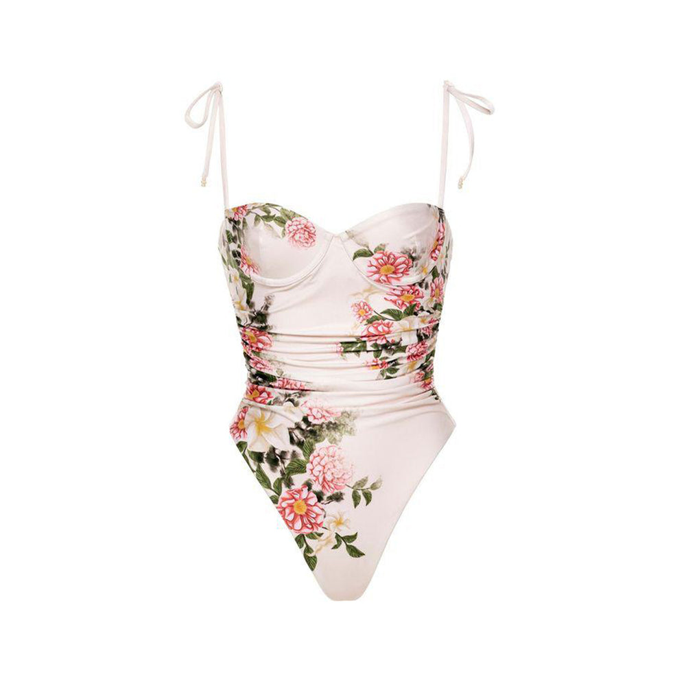 Front view of Rabano Paraiso one-piece swimsuit with pink floral print, sweetheart neckline, ruched waist, and tie shoulder straps on white background