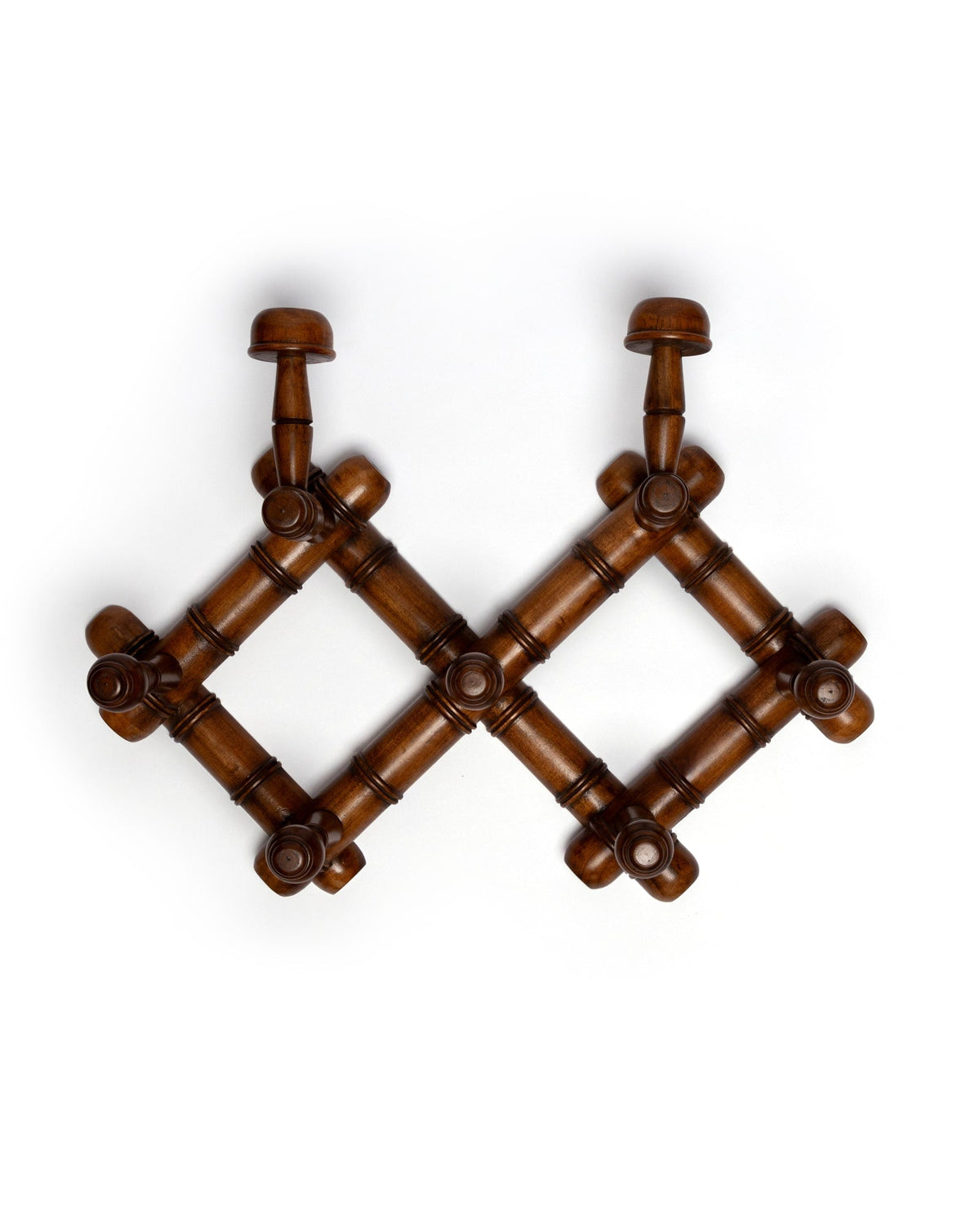 Top view of mahogany wooden accordion coat rack showing seven turned peg hooks on white background