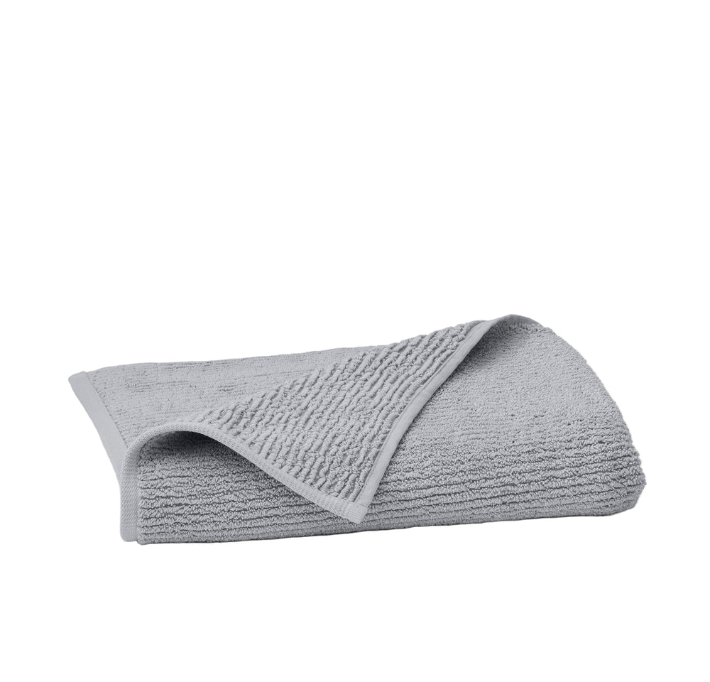 Front view of folded Turkish ribbed bath towel in Shore showcasing ribbed texture and turned corner on white background