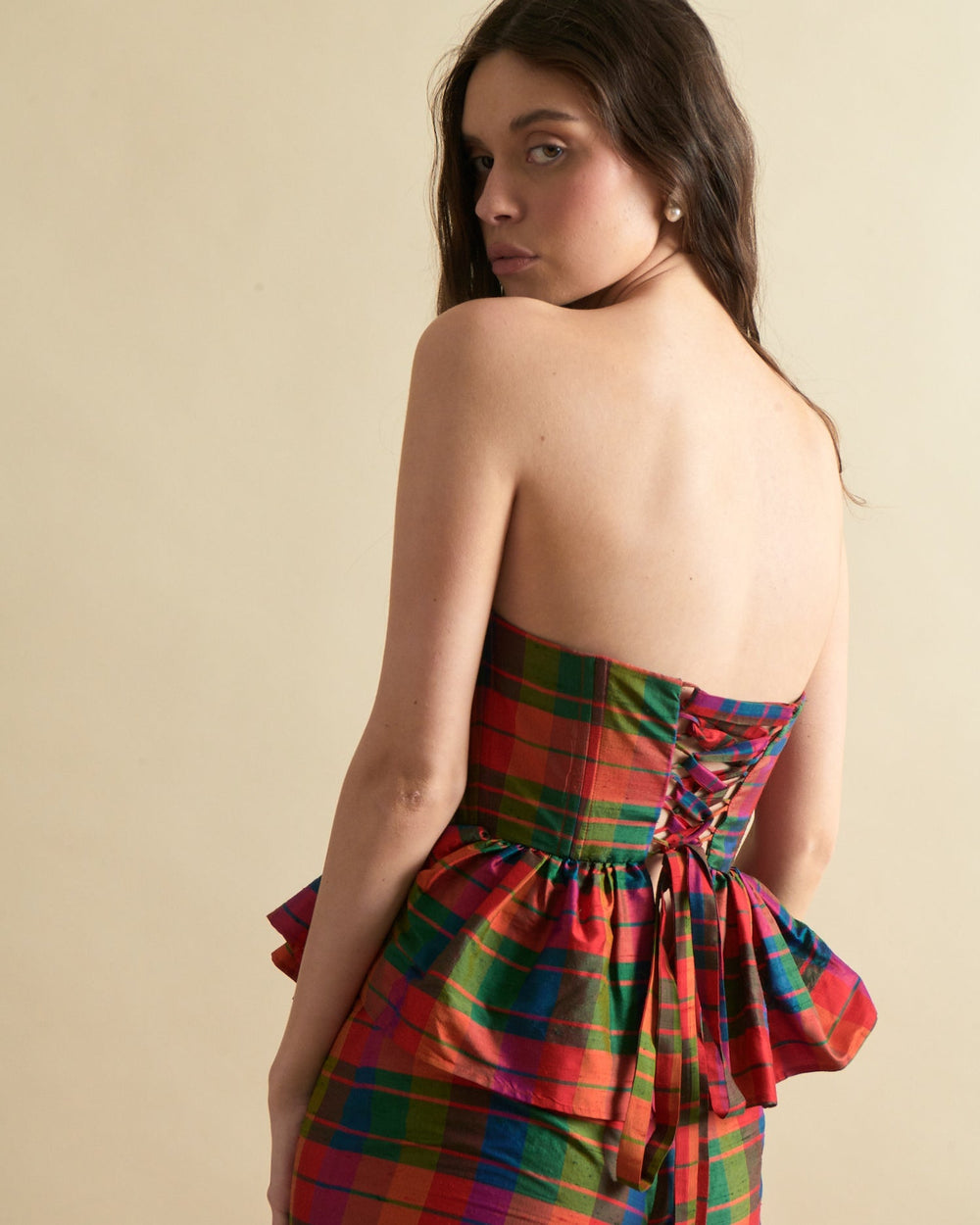 Rear view of Charlotte Bustier Top in Island Holiday showing strapless sweetheart bodice, lace-up back and peplum in colorful plaid