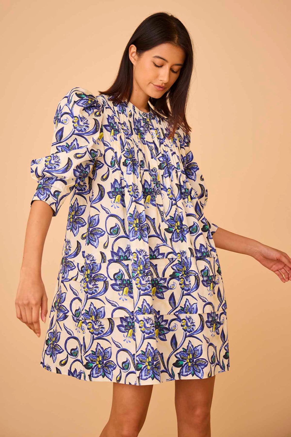 The Sidney dress has a crew neckline, ¾ length sleeves, pintucks on the bodice, and novelty buttons.