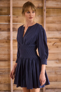 Navy diamond-smocked novelty shirting fabric with a soft V effect and blouson sleeves.