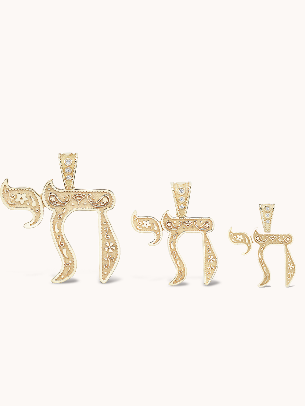 Front view of Mini Southwestern Chai Charm showing Southwestern-style engraving, shown in three sizes on pale background