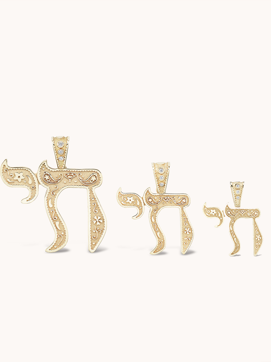 Front view of Mini Southwestern Chai Charm showing Southwestern-style engraving, shown in three sizes on pale background