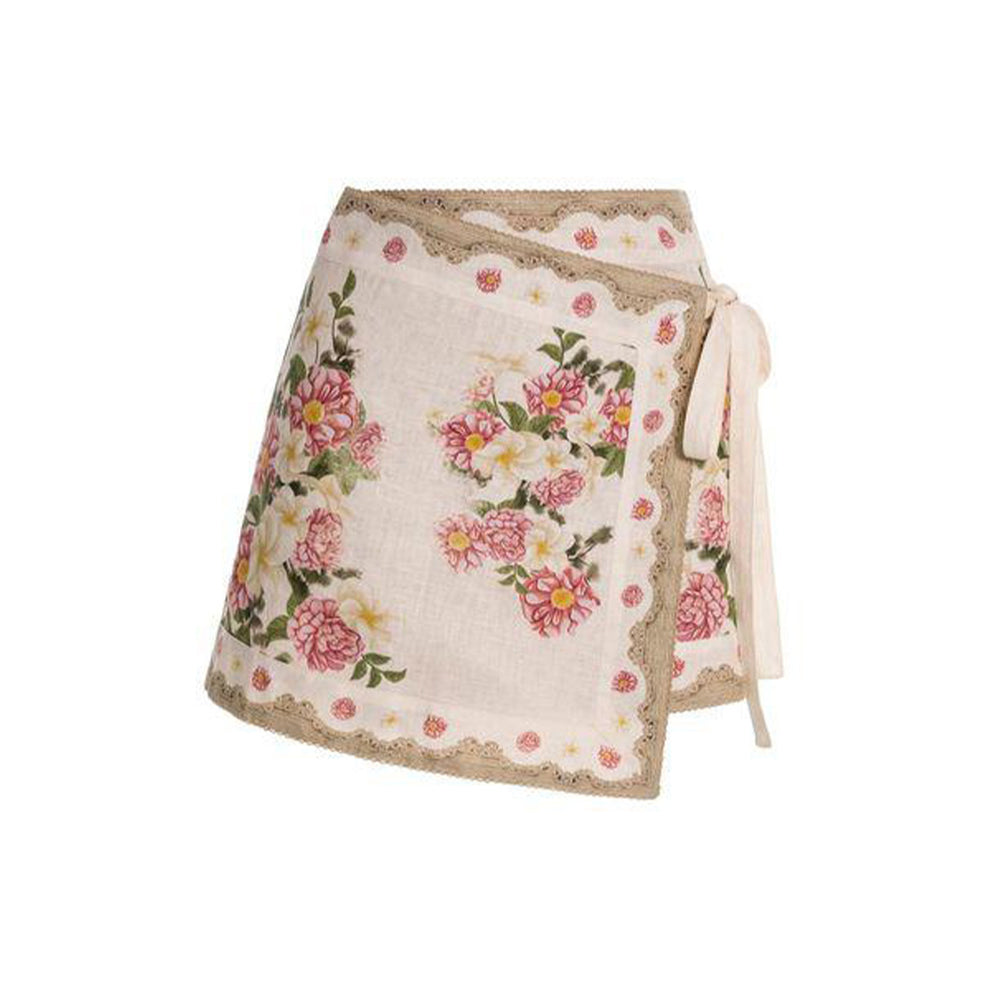 Front view of Luna Paraiso pareo showing pink floral placement print, scalloped lace trim, and tie waist on white background