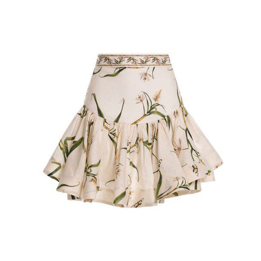 Front view of Jacarina Azucar skirt with fitted waistband, gathered ruffle mini hem, and floral print on white background