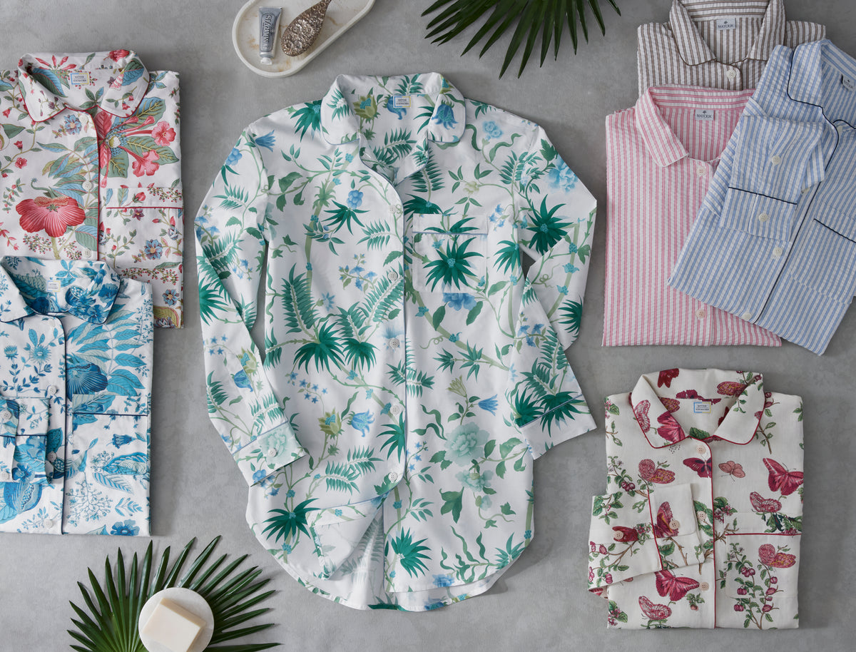 Flat lay of Valentina linen sleep shirt in green botanical print showing relaxed oversized fit and curved hem on gray background