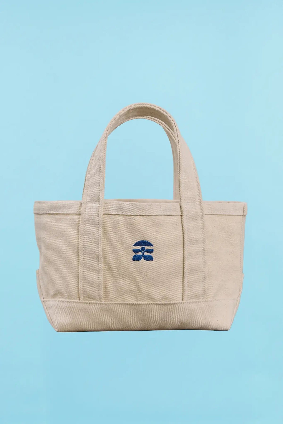 The back of the small canvas tote bag with Hunter Bell logo