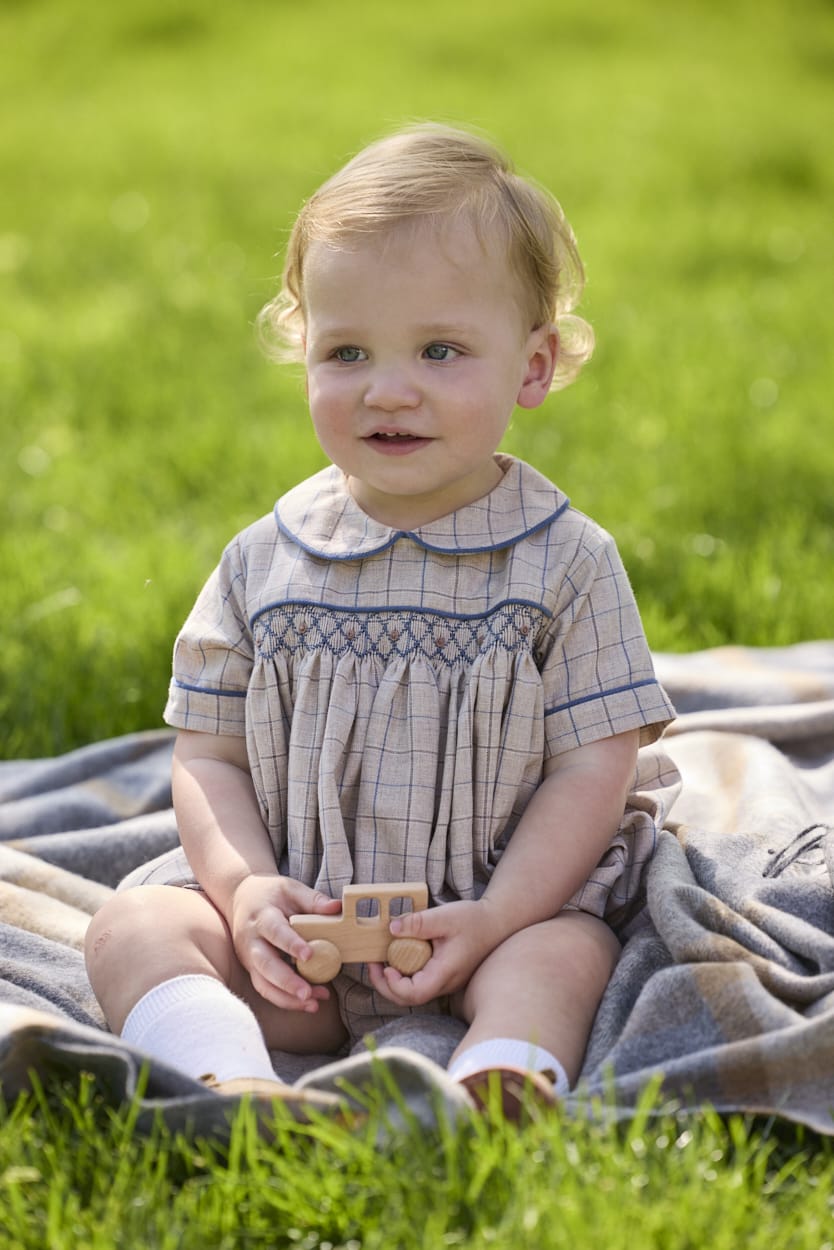Little English classic children's clothing.  Smocked peter pan bubble in tan and blue Durham windowpane with blue piping for baby boys