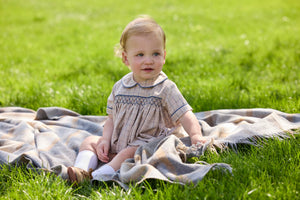 Little English classic children's clothing.  Smocked peter pan bubble in tan and blue Durham windowpane with blue piping for baby boys