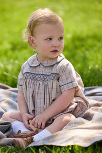 Little English classic children's clothing.  Smocked peter pan bubble in tan and blue Durham windowpane with blue piping for baby boys