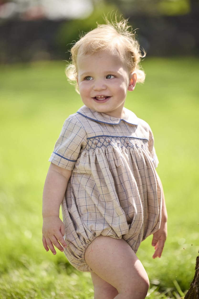 Little English classic children's clothing.  Smocked peter pan bubble in tan and blue Durham windowpane with blue piping for baby boys