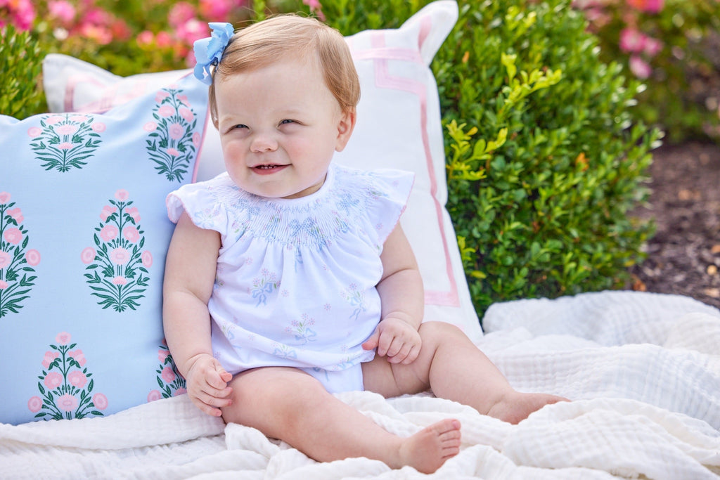 Little English traditional children's clothing.  Smocked pima cotton knit bubble with bow and flower print for baby girls for Spring