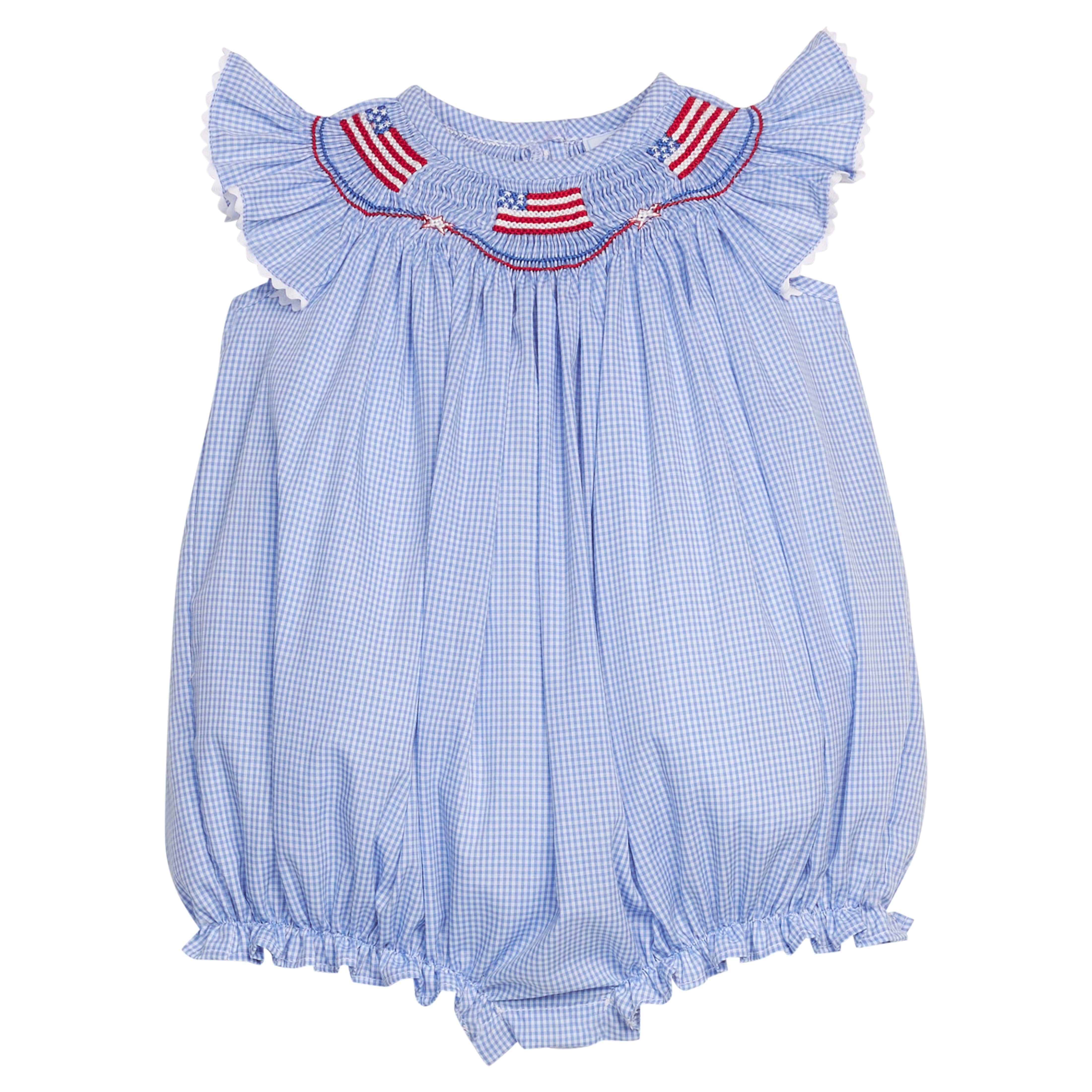 Little English traditional children's clothing.  Flutter sleeve bubble in royal blue mini check fabric and smocking with American flag bunting for baby girls