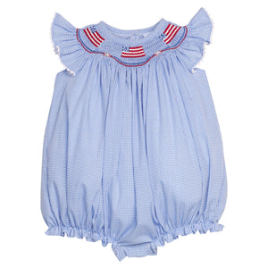 Little English traditional children's clothing.  Flutter sleeve bubble in royal blue mini check fabric and smocking with American flag bunting for baby girls