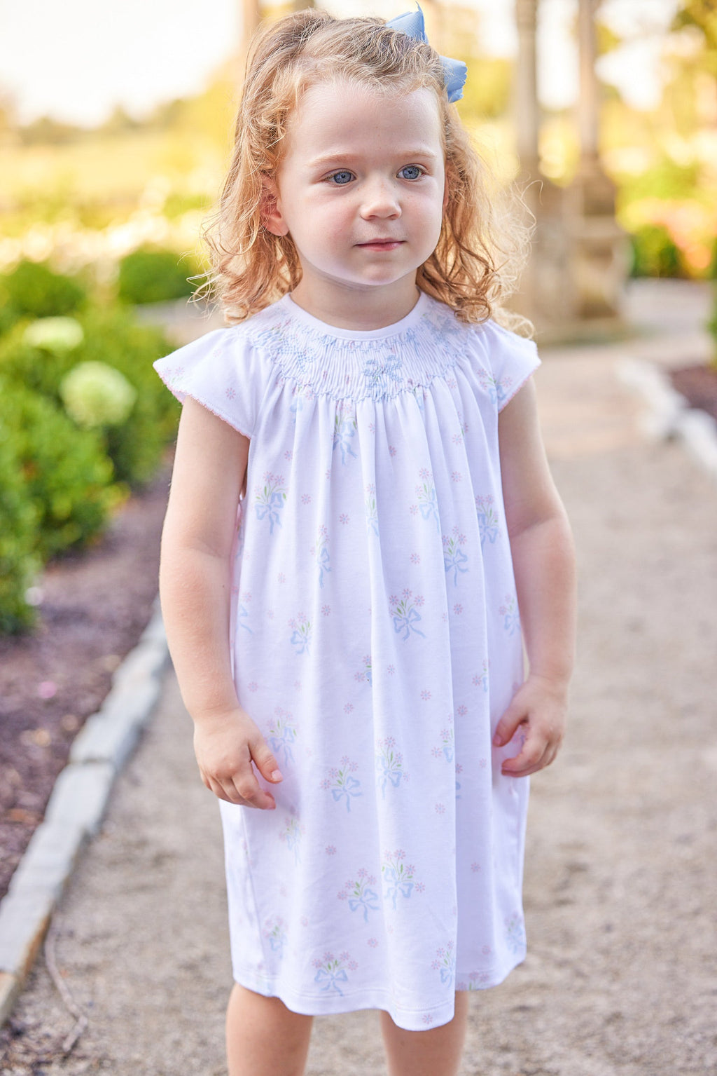 Little English traditional children's clothing.  Smocked pima cotton knit dress with bow and flower print for little girls for Spring