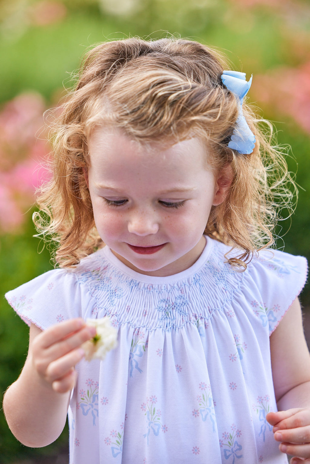 Little English traditional children's clothing.  Smocked pima cotton knit dress with bow and flower print for little girls for Spring