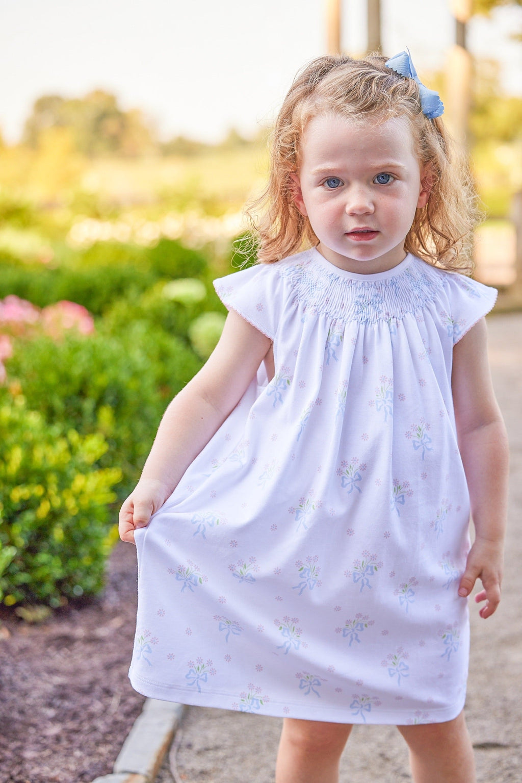 Little English traditional children's clothing.  Smocked pima cotton knit dress with bow and flower print for little girls for Spring
