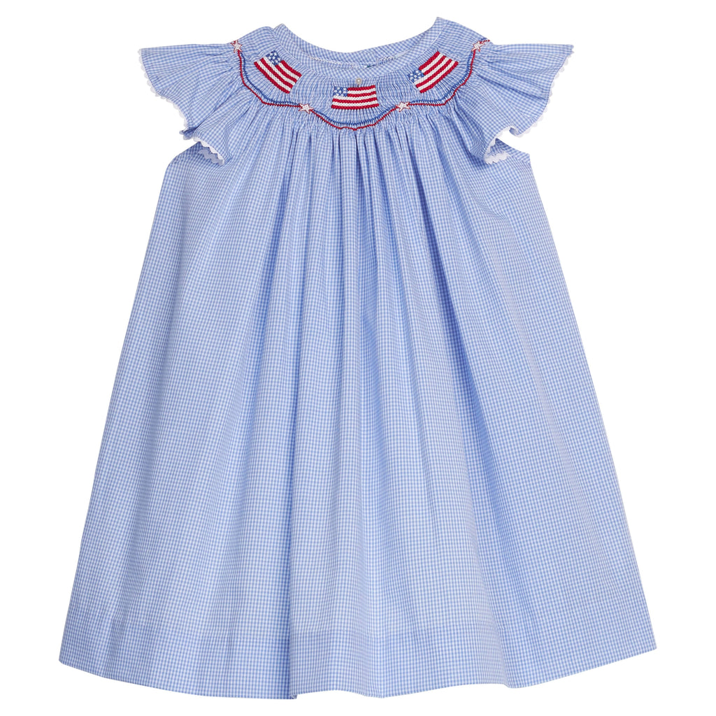 Little English traditional children's clothing. Flutter sleeve dress for toddler girls in royal blue mini gingham with smocking at the collar and American flag bunting
