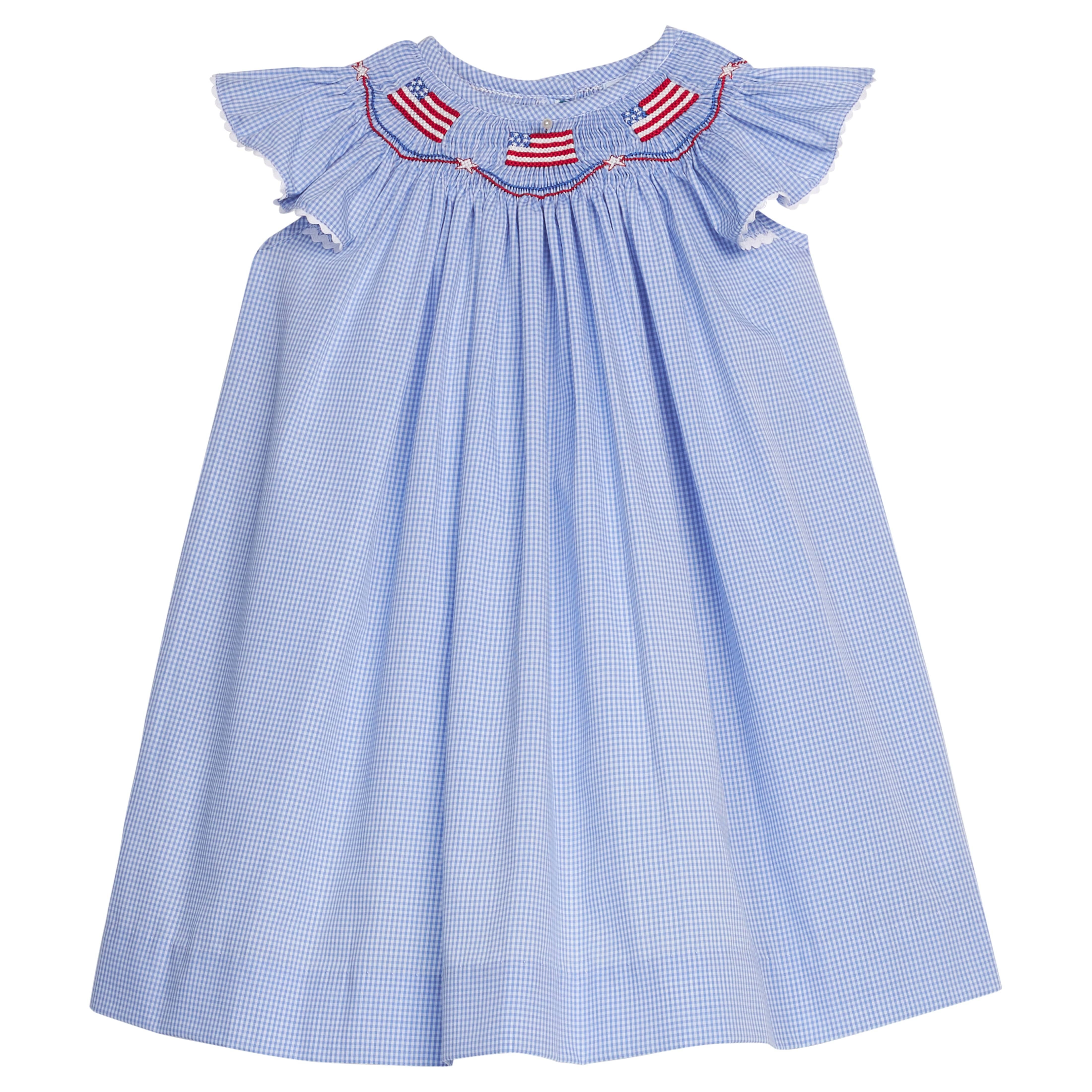 Little English traditional children's clothing. Flutter sleeve dress for toddler girls in royal blue mini gingham with smocking at the collar and American flag bunting